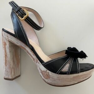 PRADA Bow distressed wooden heels.
